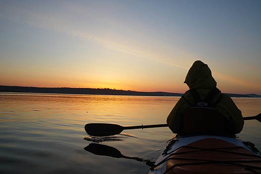 Tandem sea kayaking at sunrise.