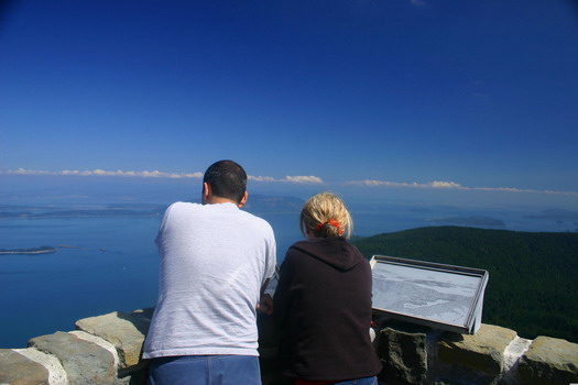 A couple enjoys the panoramic view offered from the watchtower atop Mont Constitution on Orcas Island.