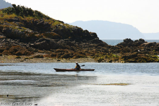 A solo sea kayaker off of Orcas Island, Washington State.